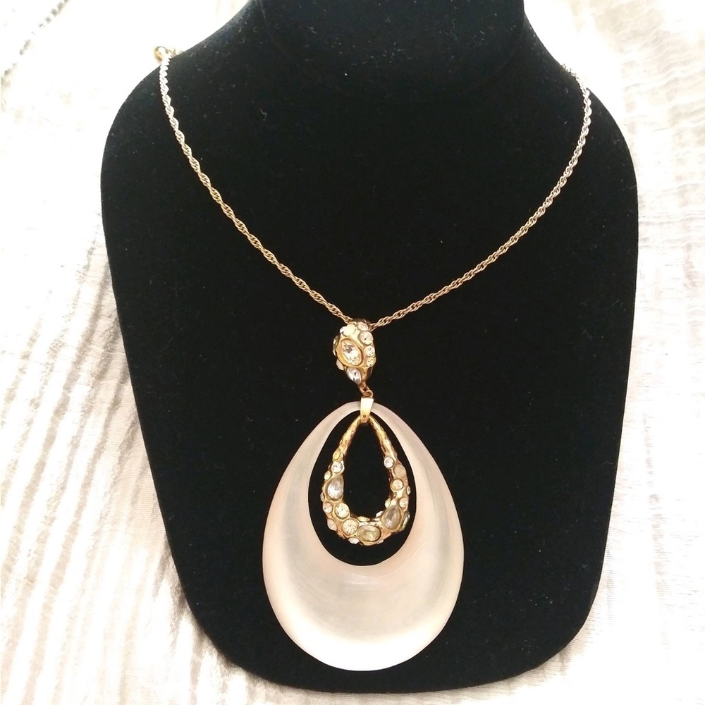 Alexis Bittar champagne color lucite in gold tone setting with crystals.